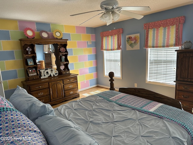 2270 Bella Coola Rd, Lake Waccamaw, NC 28450 - bedroom with a textured ceiling, ceiling fan, and wood finished floors