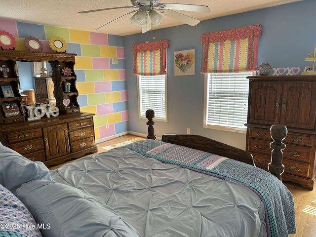 2270 Bella Coola Rd, Lake Waccamaw, NC 28450 - bedroom featuring light wood finished floors, multiple windows, a ceiling fan, and a textured ceiling