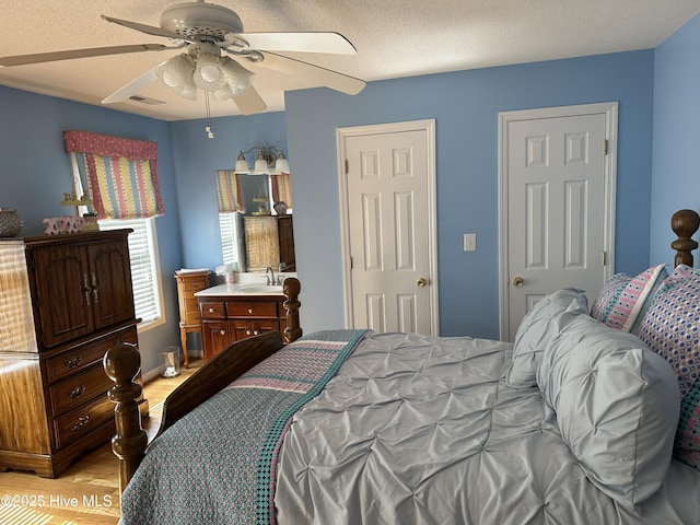 2270 Bella Coola Rd, Lake Waccamaw, NC 28450 - bedroom with light wood finished floors and ceiling fan