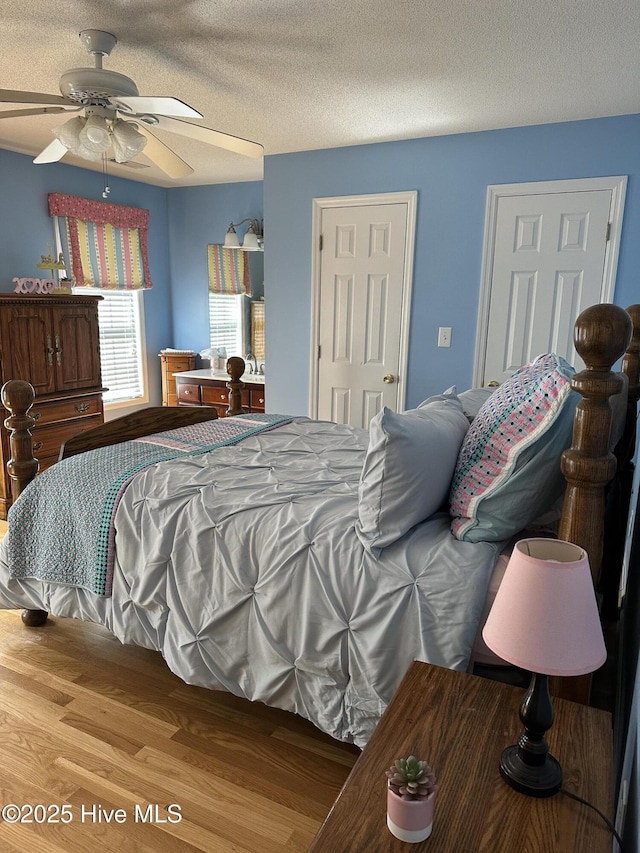 2270 Bella Coola Rd, Lake Waccamaw, NC 28450 - bedroom featuring a ceiling fan, a textured ceiling, and wood finished floors
