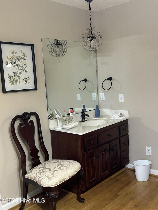 2270 Bella Coola Rd, Lake Waccamaw, NC 28450 - bathroom with wood finished floors, vanity, and a chandelier