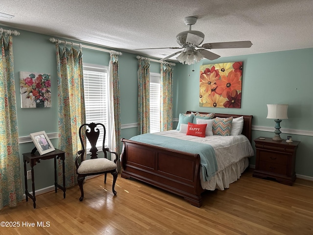 2270 Bella Coola Rd, Lake Waccamaw, NC 28450 - bedroom featuring a textured ceiling, wood finished floors, and a ceiling fan