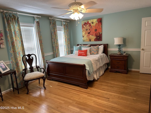 2270 Bella Coola Rd, Lake Waccamaw, NC 28450 - bedroom with light wood finished floors, a textured ceiling, and ceiling fan