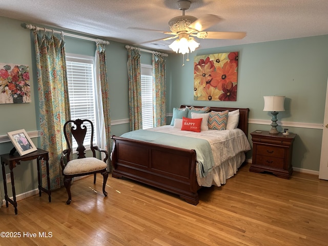 2270 Bella Coola Rd, Lake Waccamaw, NC 28450 - bedroom with light wood-style floors, a textured ceiling, and ceiling fan