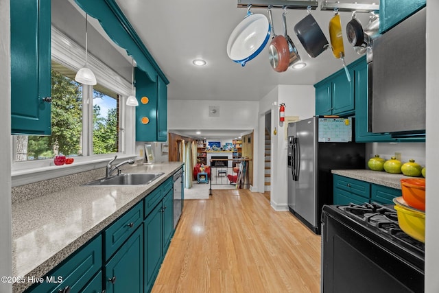 604 W Wilson Creek Dr, Trent Woods, NC 28562 - kitchen with stainless steel appliances, light wood-type flooring, hanging light fixtures, and light countertops