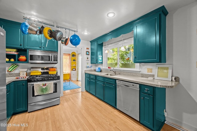 604 W Wilson Creek Dr, Trent Woods, NC 28562 - kitchen featuring stainless steel appliances, light wood finished floors, open shelves, and light countertops