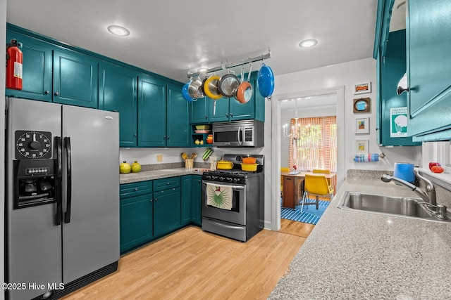604 W Wilson Creek Dr, Trent Woods, NC 28562 - kitchen featuring stainless steel appliances, a chandelier, light wood-type flooring, and light countertops