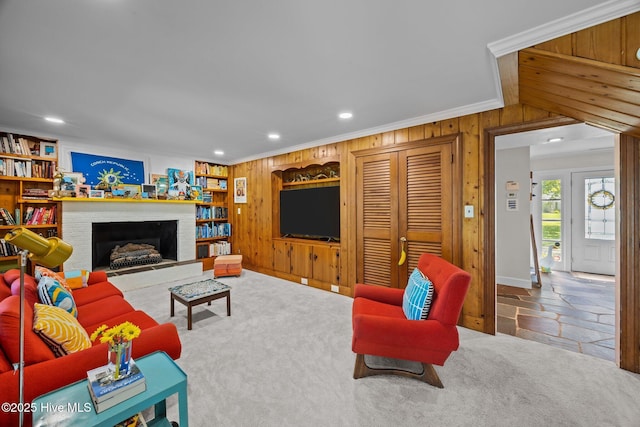 604 W Wilson Creek Dr, Trent Woods, NC 28562 - living room featuring recessed lighting, wooden walls, ornamental molding, a brick fireplace, and stone finish flooring