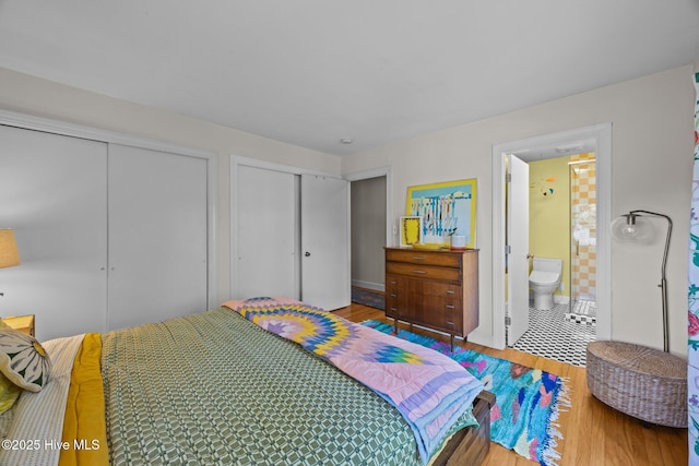 604 W Wilson Creek Dr, Trent Woods, NC 28562 - bedroom with two closets, wood finished floors, and ensuite bathroom