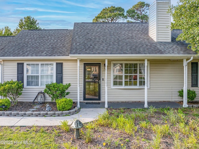 165 Parnell Rd, Hubert, NC 28539 - view of front facade featuring roof with shingles and a chimney