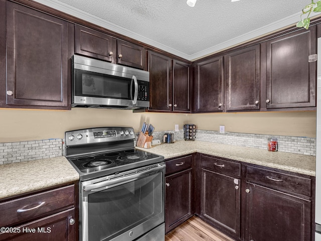 165 Parnell Rd, Hubert, NC 28539 - kitchen with appliances with stainless steel finishes, dark brown cabinetry, light countertops, a textured ceiling, and light wood-style floors