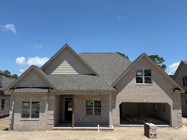 453 Motts Forest Rd Unit 70, Wilmington, NC 28412 - view of front facade featuring brick siding, a shingled roof, and a garage