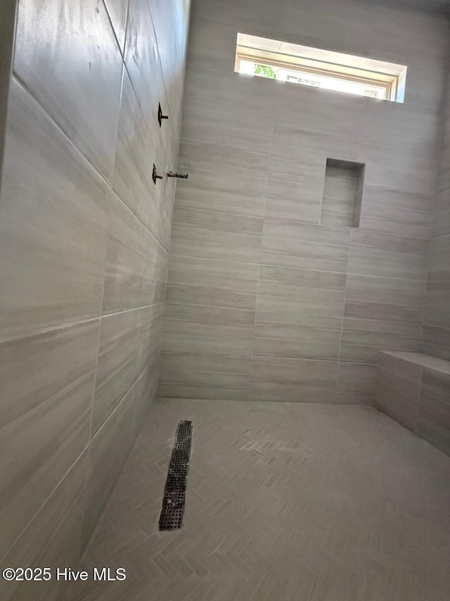 453 Motts Forest Rd Unit 70, Wilmington, NC 28412 - bathroom featuring a tile shower and healthy amount of natural light