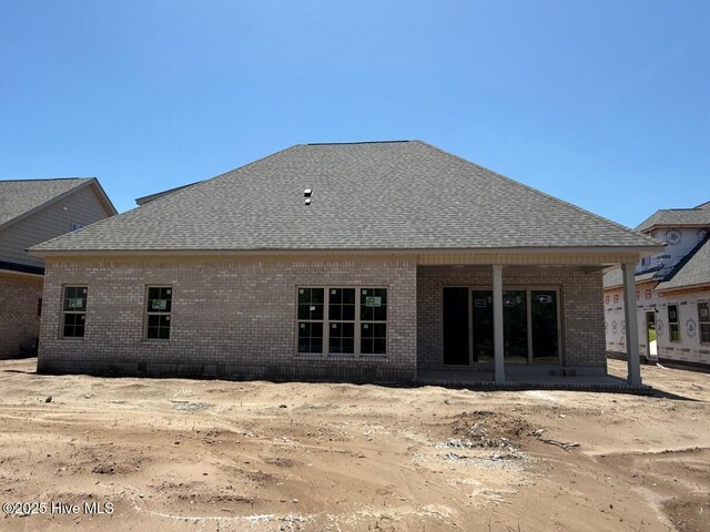 453 Motts Forest Rd Unit 70, Wilmington, NC 28412 - rear view of property featuring brick siding, a shingled roof, and covered porch