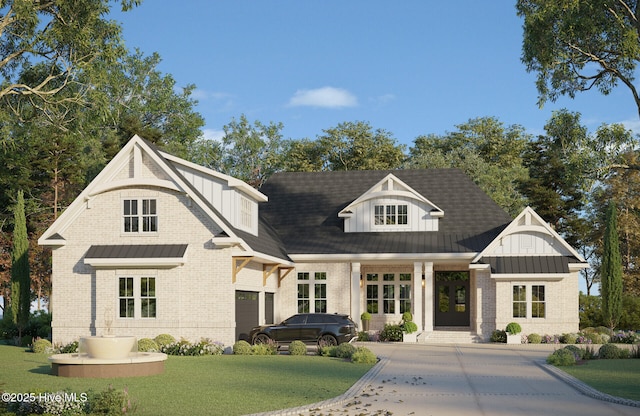 805 Wild Turkey Pl, Wilmington, NC 28405 - view of front of house with brick siding, french doors, a standing seam roof, a front yard, and a metal roof