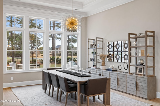 805 Wild Turkey Pl, Wilmington, NC 28405 - dining room with ornamental molding, light wood-type flooring, a chandelier, a tray ceiling, and a high ceiling
