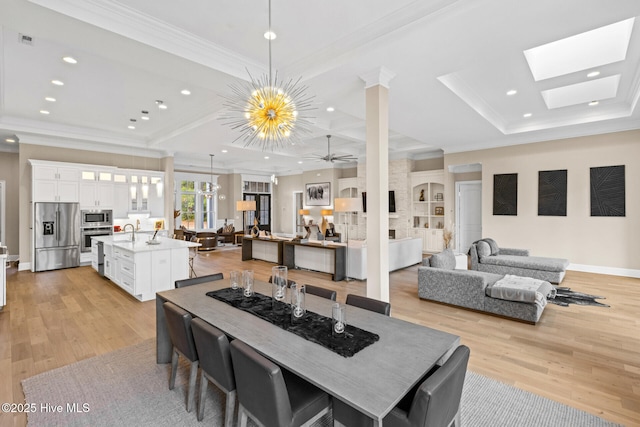 805 Wild Turkey Pl, Wilmington, NC 28405 - dining space with crown molding, light wood finished floors, recessed lighting, ceiling fan, and a skylight