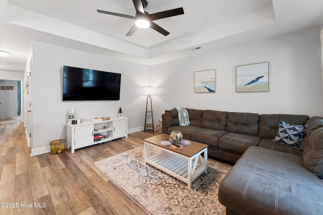 126 NW 14th St, Oak Island, NC 28465 - living area featuring a raised ceiling, a ceiling fan, and wood finished floors