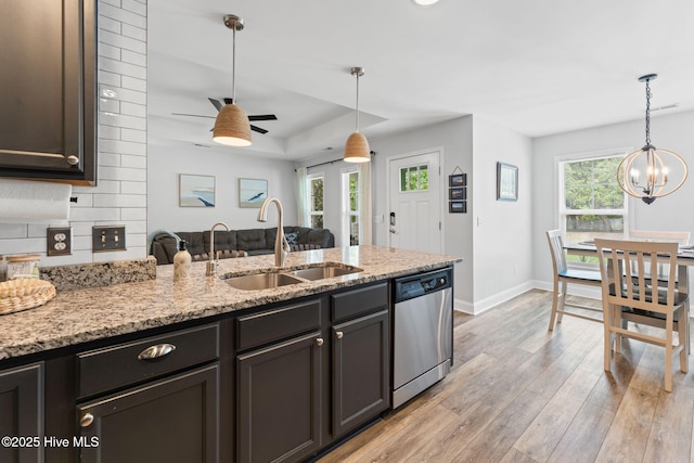 126 NW 14th St, Oak Island, NC 28465 - kitchen with dishwasher, light wood-type flooring, decorative light fixtures, and a peninsula