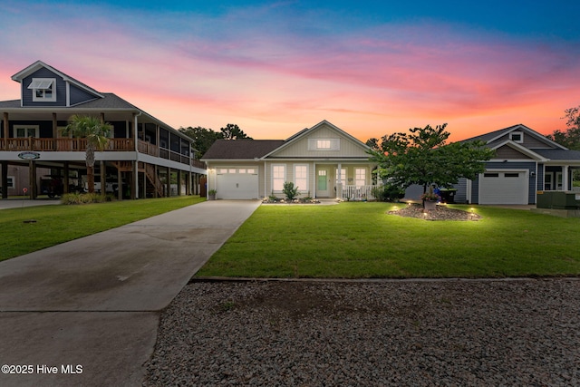 126 NW 14th St, Oak Island, NC 28465 - view of front of property with an attached garage, driveway, a front yard, and covered porch