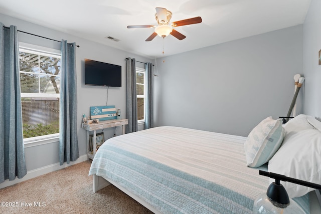 126 NW 14th St, Oak Island, NC 28465 - bedroom with light carpet and a ceiling fan