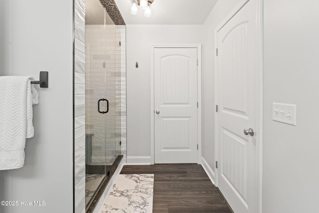 126 NW 14th St, Oak Island, NC 28465 - bathroom featuring a shower stall and wood finished floors