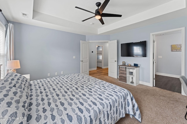126 NW 14th St, Oak Island, NC 28465 - bedroom with a tray ceiling, carpet floors, and ceiling fan