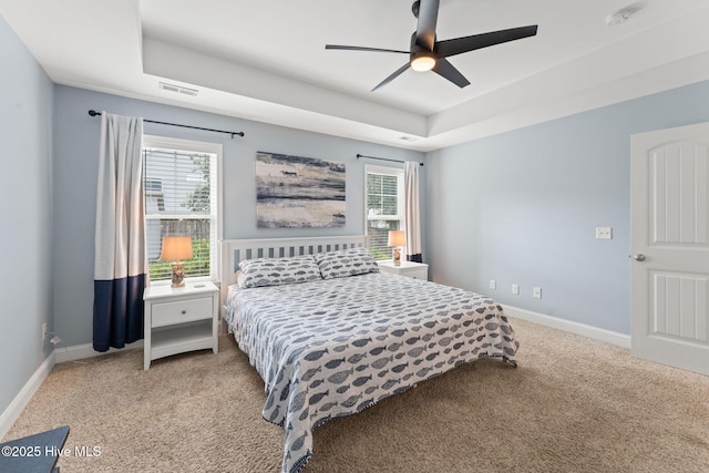 126 NW 14th St, Oak Island, NC 28465 - carpeted bedroom with a raised ceiling and ceiling fan