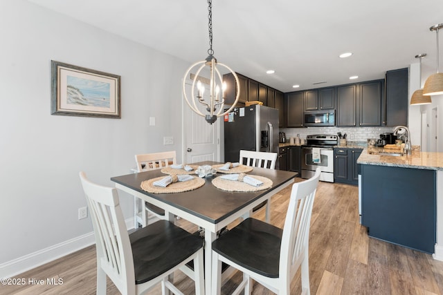 126 NW 14th St, Oak Island, NC 28465 - dining area featuring a chandelier and light wood-style flooring