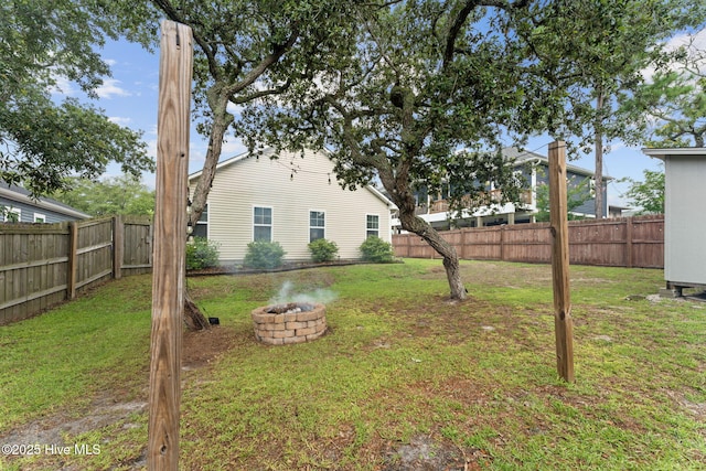 126 NW 14th St, Oak Island, NC 28465 - fenced backyard featuring an outdoor fire pit