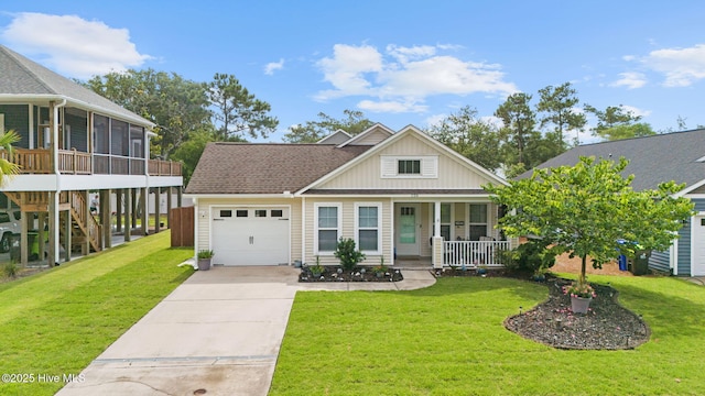 126 NW 14th St, Oak Island, NC 28465 - view of front of home with covered porch, a garage, driveway, a sunroom, and a front lawn