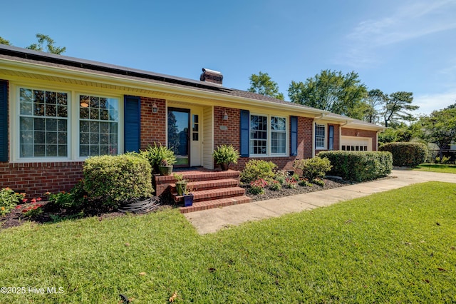 3921 Westover Rd, Wilmington, NC 28403 - ranch-style home featuring an attached garage, a front yard, brick siding, and a chimney