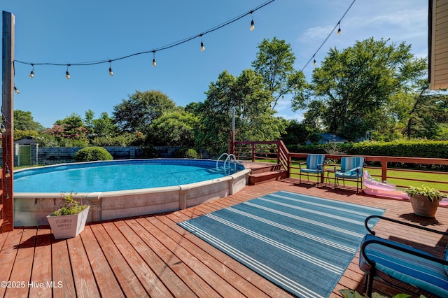 3921 Westover Rd, Wilmington, NC 28403 - view of swimming pool with a wooden deck, a fenced backyard, and view of wooded area