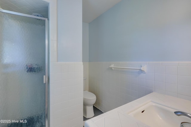 3921 Westover Rd, Wilmington, NC 28403 - bathroom featuring a stall shower, tile walls, and wainscoting