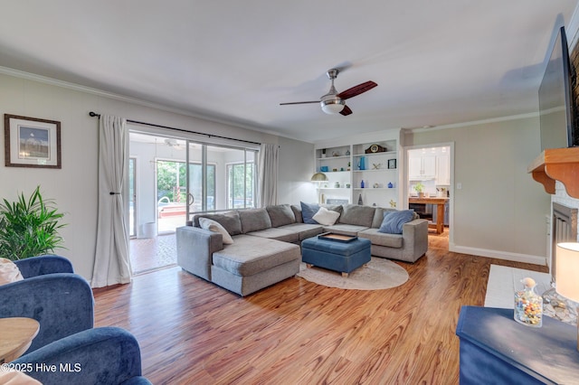 3921 Westover Rd, Wilmington, NC 28403 - living area with light wood finished floors, a ceiling fan, and ornamental molding