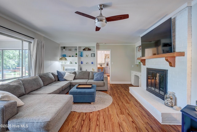 3921 Westover Rd, Wilmington, NC 28403 - living area featuring ceiling fan, a fireplace, wood finished floors, and ornamental molding