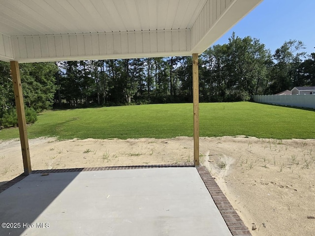 94 Osprey Watch Ln E, Oriental, NC 28571 - view of green lawn featuring a patio area and view of wooded area