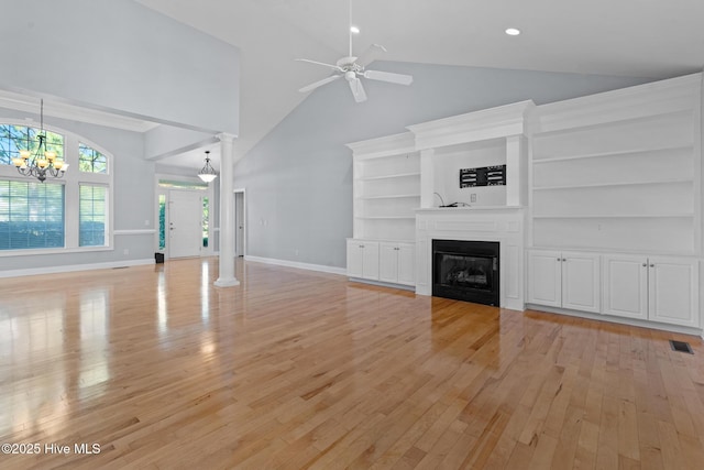 183 Baker Cir W, End, NC 27376 - unfurnished living room with high vaulted ceiling, a ceiling fan, light wood-type flooring, a chandelier, and a glass covered fireplace