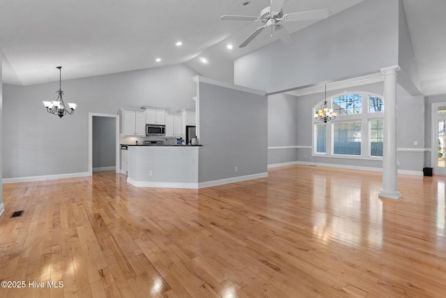 183 Baker Cir W, End, NC 27376 - unfurnished living room featuring a chandelier, high vaulted ceiling, ceiling fan, light wood-style flooring, and ornate columns