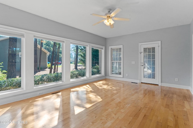 183 Baker Cir W, End, NC 27376 - unfurnished sunroom with baseboards and wood finished floors