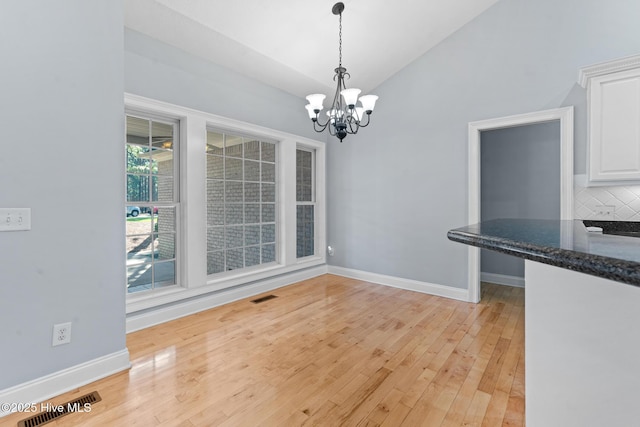 183 Baker Cir W, End, NC 27376 - unfurnished dining area with a chandelier, light wood finished floors, and lofted ceiling