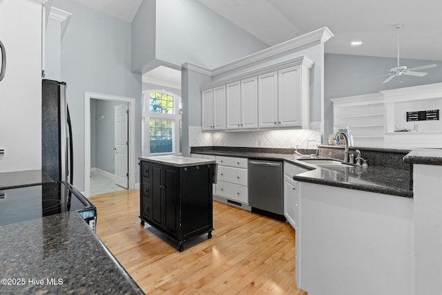 183 Baker Cir W, End, NC 27376 - kitchen with dishwasher, fridge, ceiling fan, vaulted ceiling, and light wood-style flooring