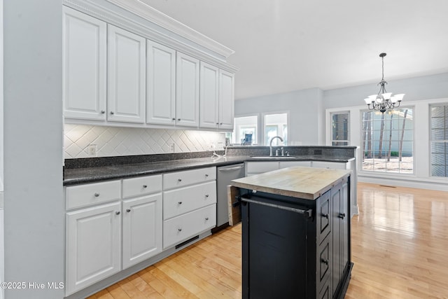 183 Baker Cir W, End, NC 27376 - kitchen featuring stainless steel dishwasher, wood counters, light wood-style flooring, and a chandelier