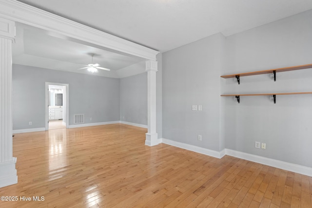 183 Baker Cir W, End, NC 27376 - unfurnished room featuring decorative columns, a ceiling fan, and light wood-style floors