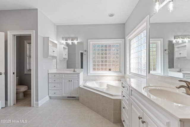 183 Baker Cir W, End, NC 27376 - full bathroom with a chandelier, tile patterned flooring, a garden tub, and two vanities