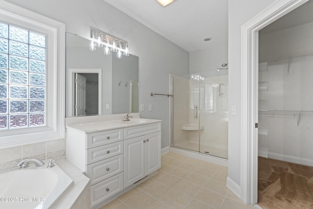 183 Baker Cir W, End, NC 27376 - bathroom with a shower stall, vanity, a bath, a walk in closet, and tile patterned flooring