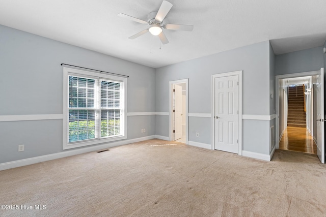 183 Baker Cir W, End, NC 27376 - unfurnished bedroom featuring carpet floors, ensuite bathroom, and ceiling fan