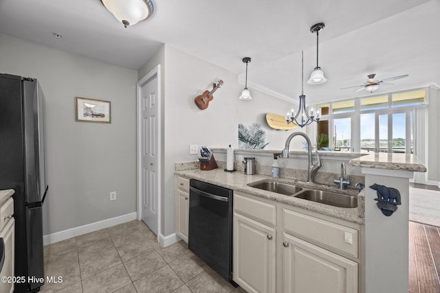 219 Sky Sail Blvd, New Bern, NC 28560 - kitchen with freestanding refrigerator, black dishwasher, a peninsula, a ceiling fan, and pendant lighting
