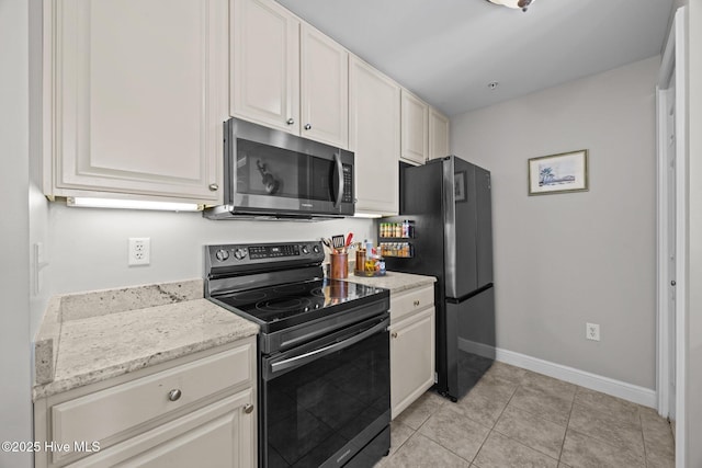 219 Sky Sail Blvd, New Bern, NC 28560 - kitchen featuring stainless steel microwave, electric stove, freestanding refrigerator, light tile patterned floors, and light stone countertops