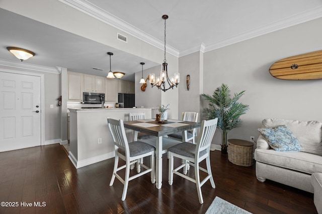 219 Sky Sail Blvd, New Bern, NC 28560 - dining area with crown molding, a chandelier, and dark wood-style floors